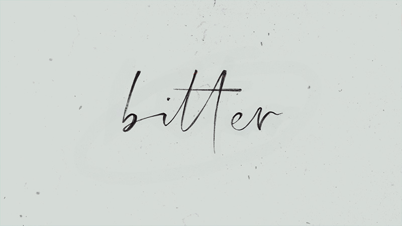 Cover still of the Bitter lyric video featuring handwritten title text on a soft, grainy background with a minimalist, emotional tone.