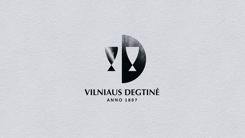 Minimalist black-and-white logo of Vilniaus Degtine with abstract glass and letter “D” shapes, featuring the text “Anno 1897” below.